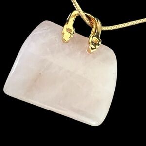 Rose quartz purse pendant plus a gold plated necklace